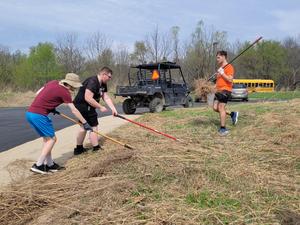 Students remove invasive species at Pierce Cedar Creek.