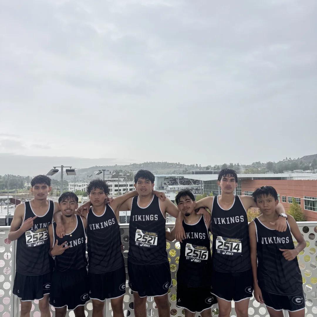 about 9 members of the varsity track team in the rain