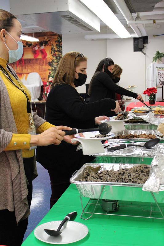 4 women serving themselves food from platters