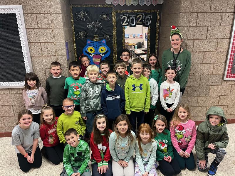 a group of students sitting in a school hallway