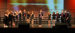group of high schoolers singing on stage