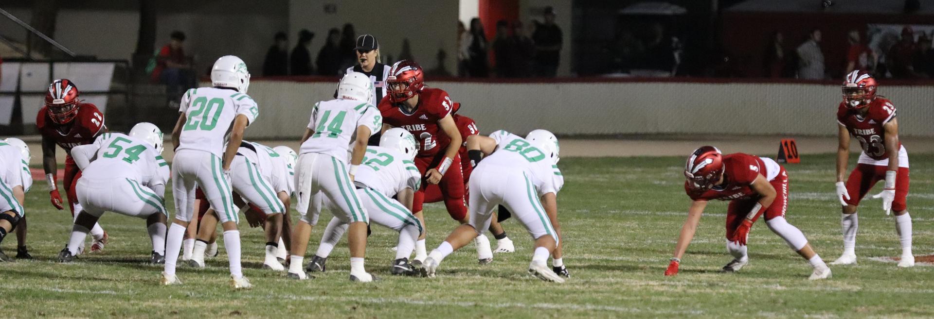 varsity football players in action against Riverdale