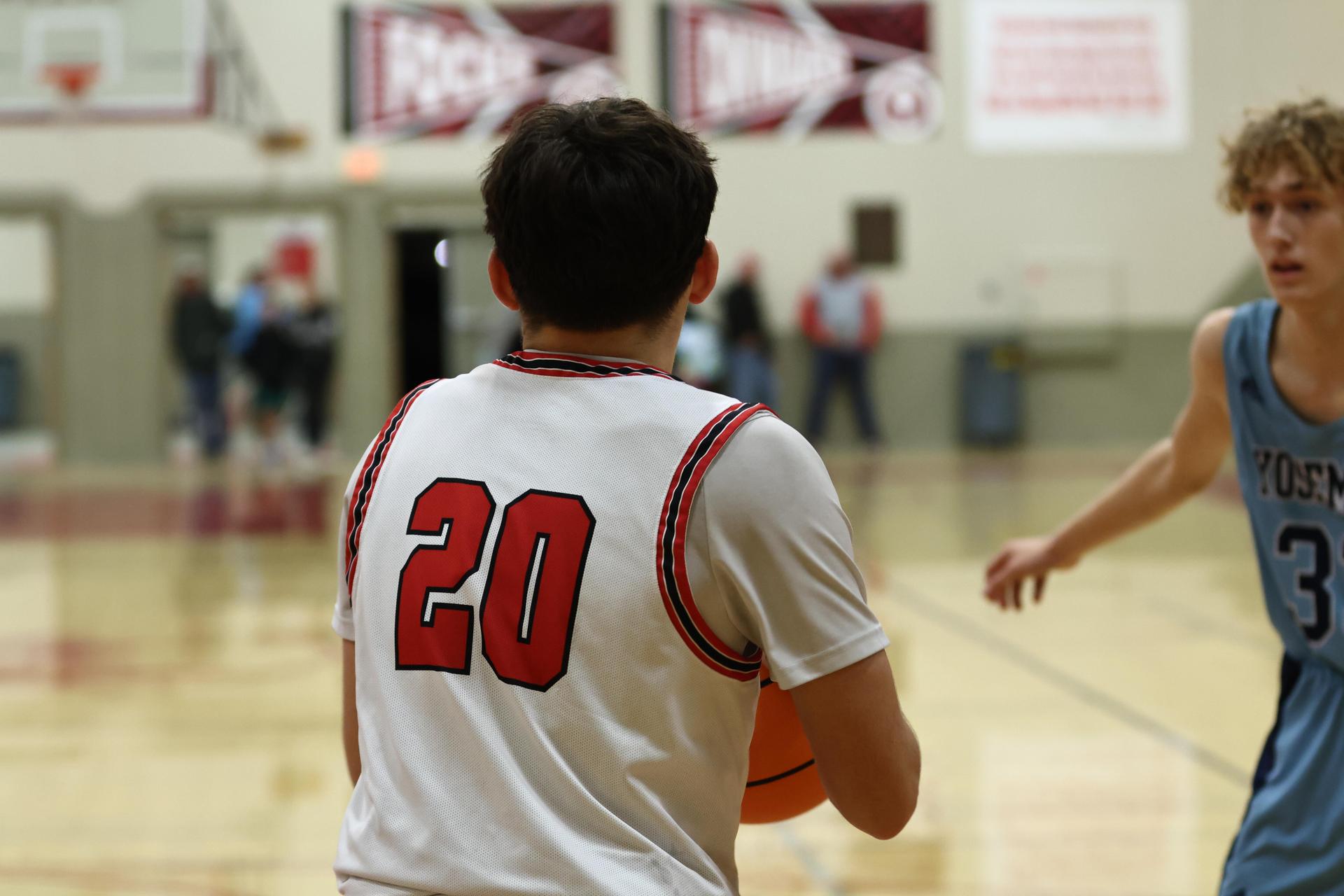 Varsity boys playing basketball against yosemite