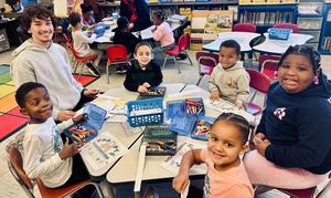 elementary and high school students together at a table