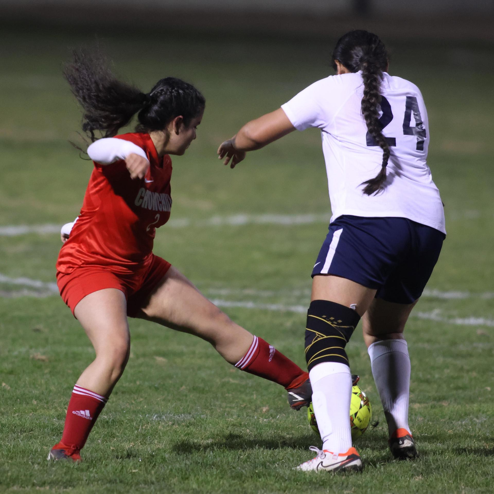 Varsity girls playing soccer against sunnyside