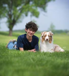Sawyer Johnson laying with dog