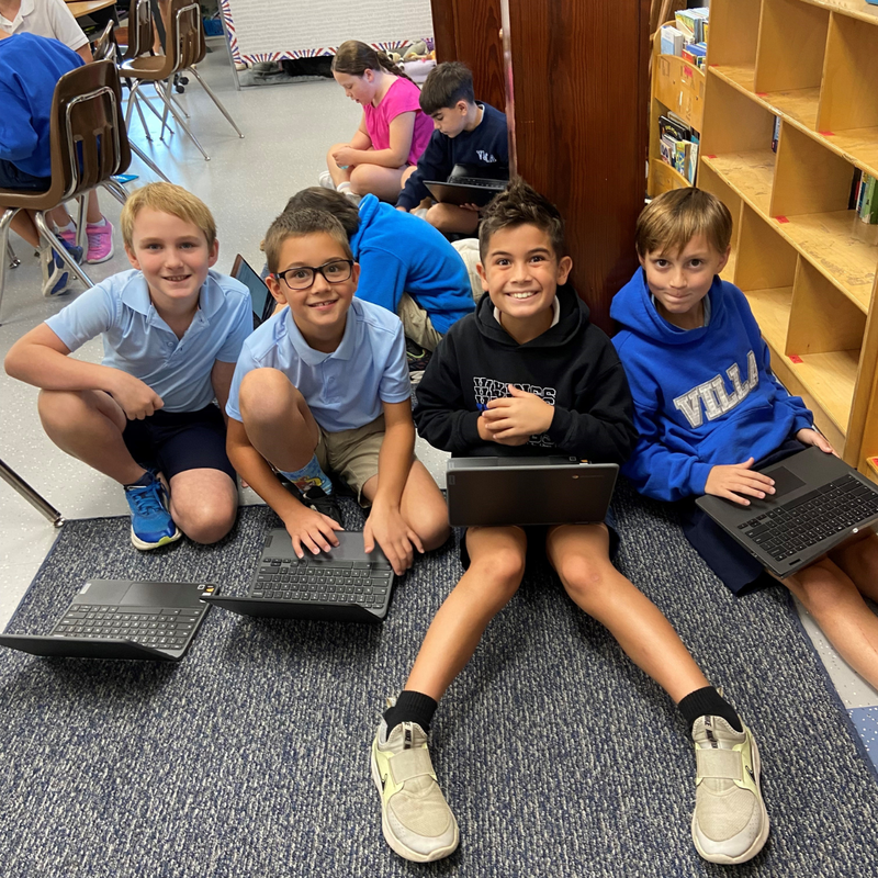 Fourth grade boys work on laptops in Prodigy Math Competition