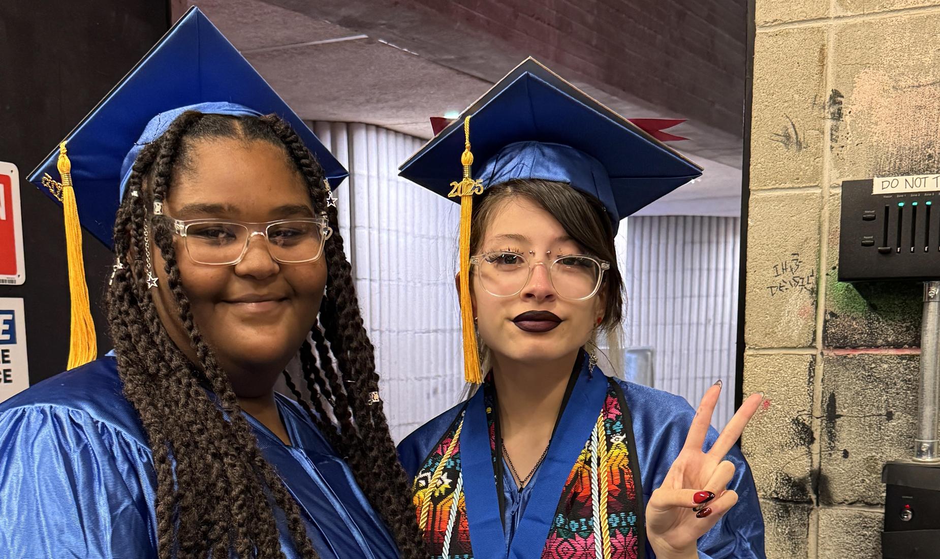 Two female students in cap and gown.