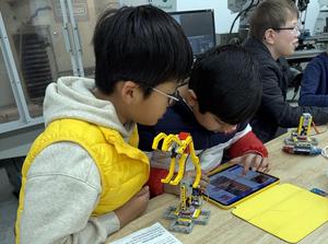 two boys working on a tablet computer