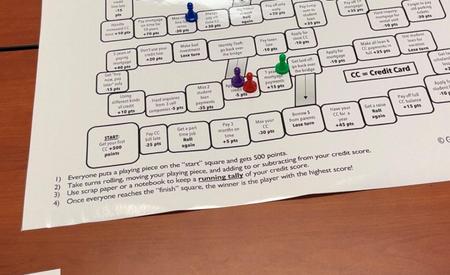 A game board with rules, colorful pieces, and tasks written for gameplay on a table.