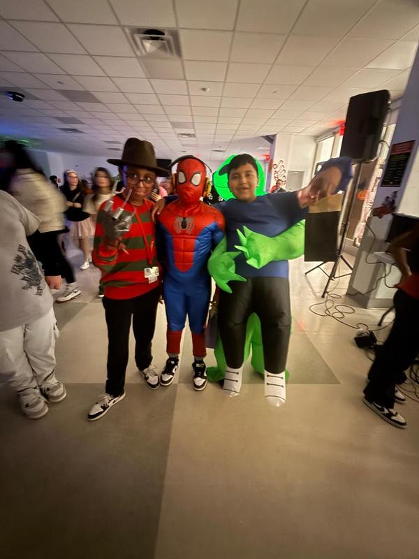 3 students standing in their costumes