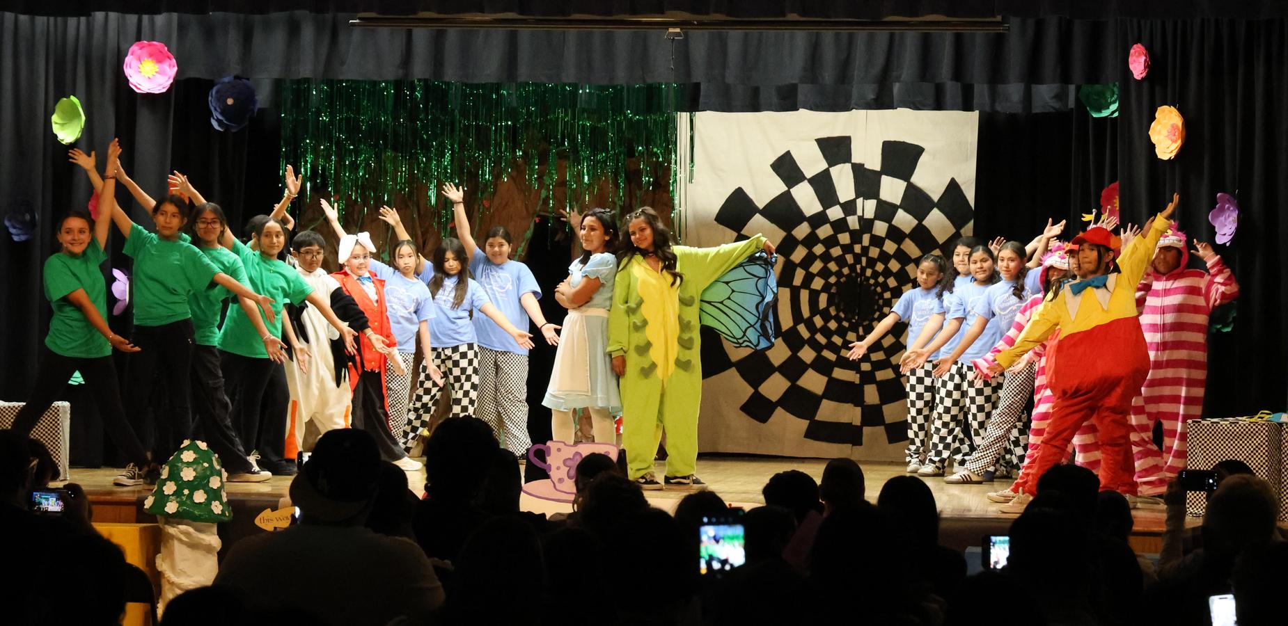Students performing in Alice Jr the musical