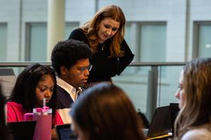 Students discuss around a table