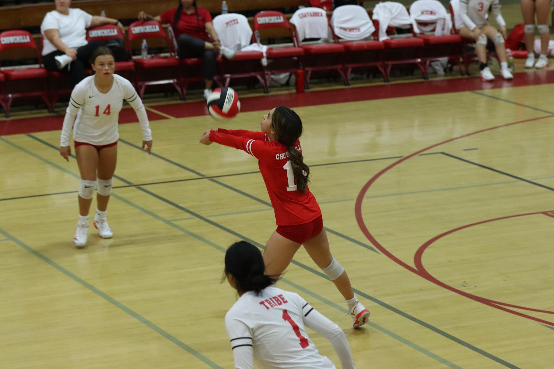 varsity volleyball players in action against liberty
