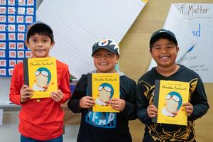 united we read event, three boys smiling with books