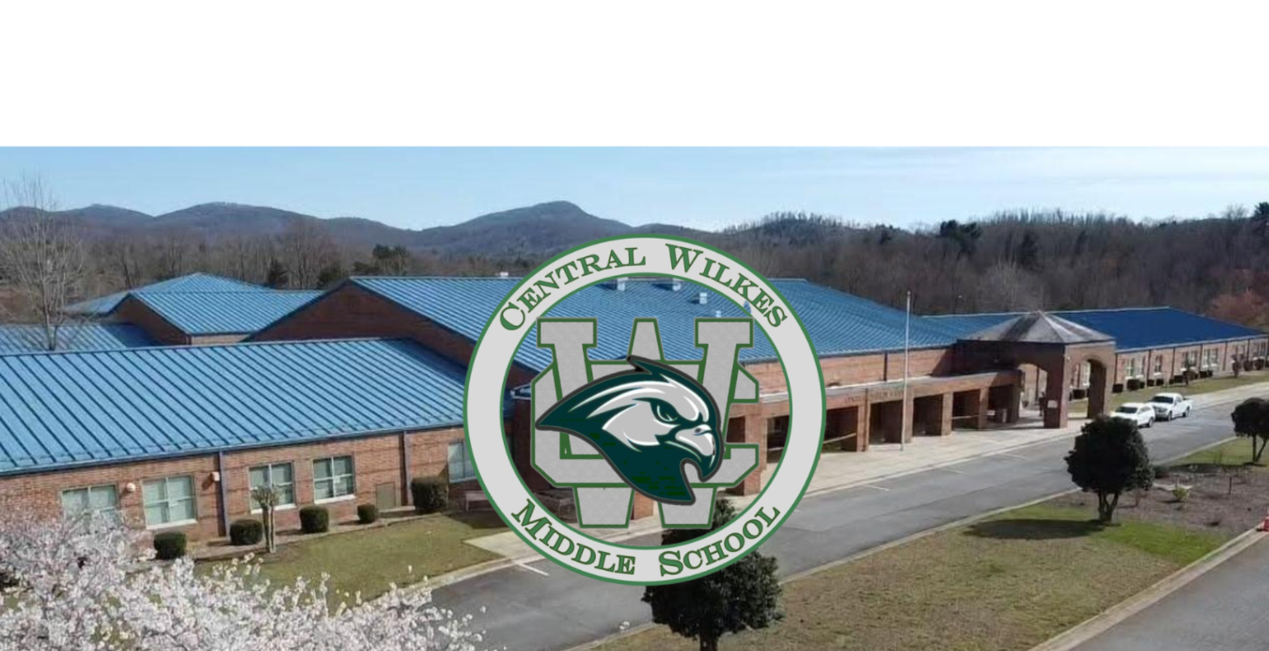Central Wilkes Middle School building with mountains in the background and logo overlay.