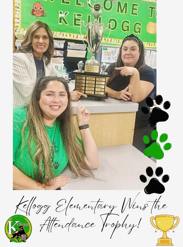 Principal with staff showing their attendance trophy