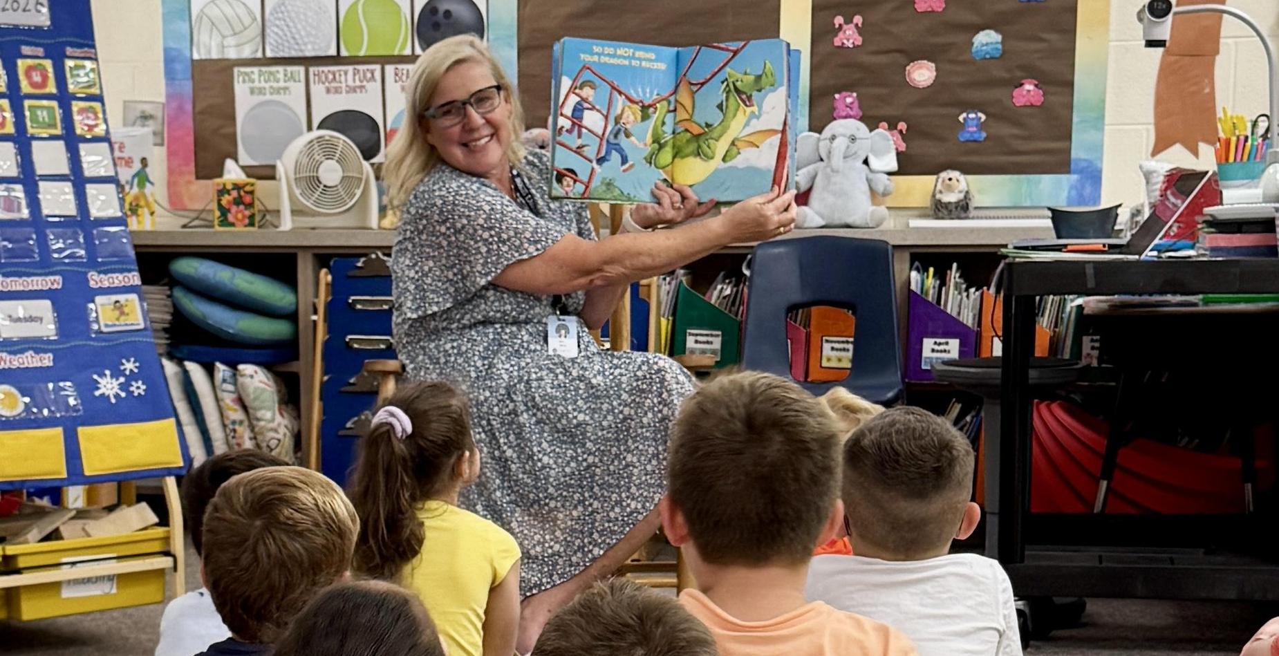 Principal reads to kindergarten students.