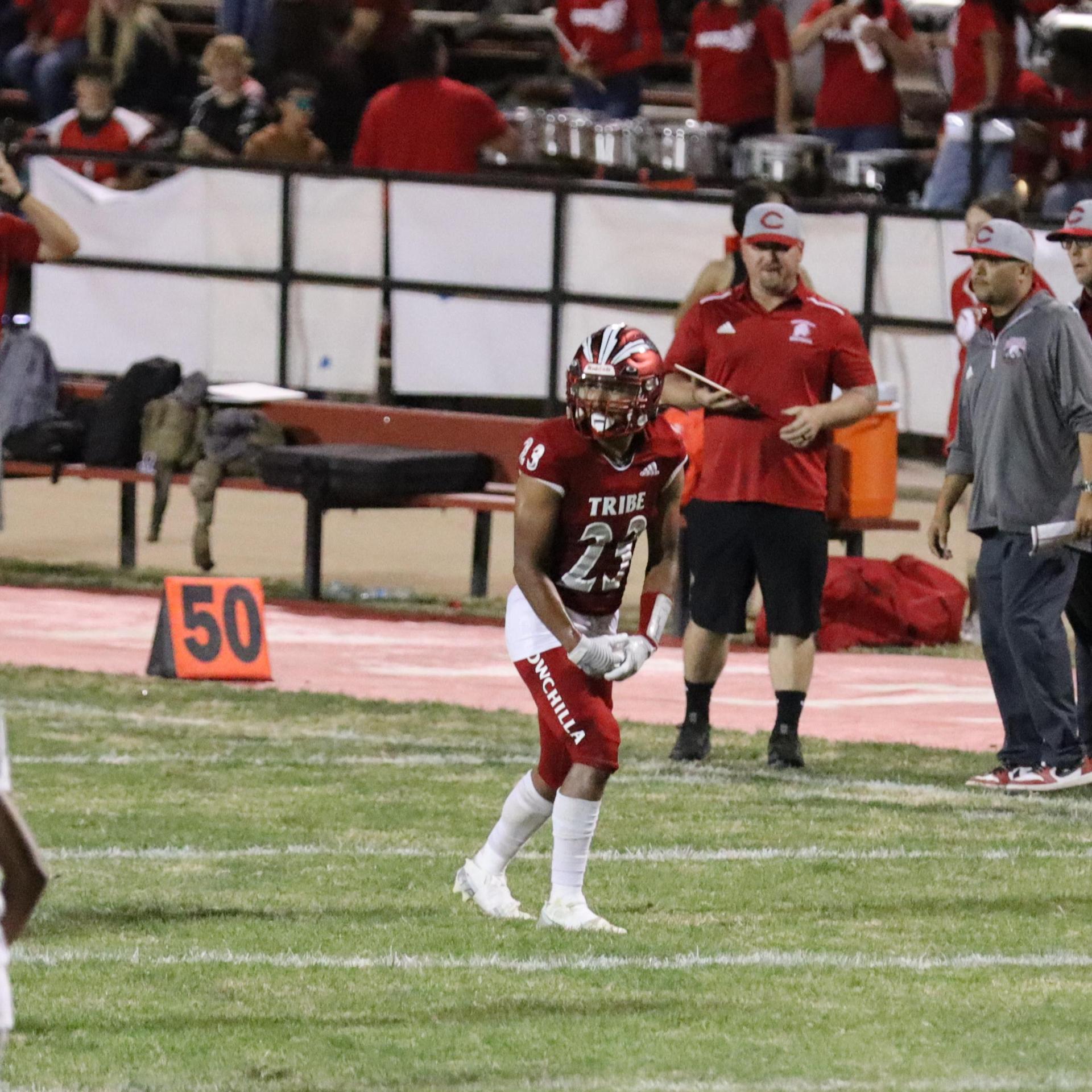 varsity football players in action against Riverdale