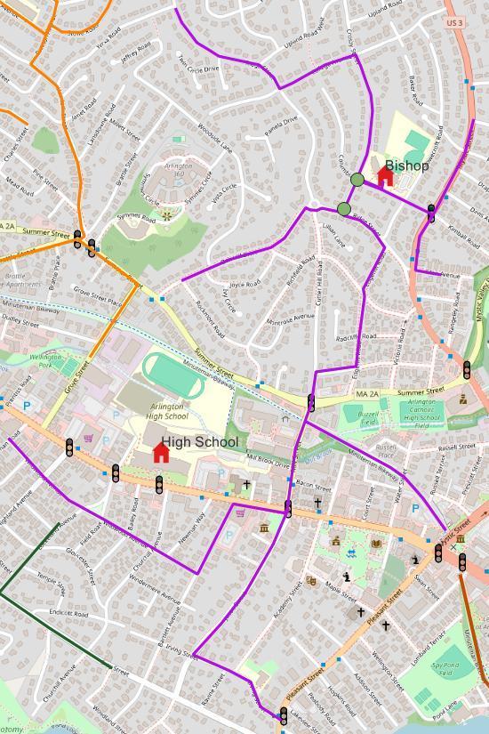 Map of the Bishop Elementary School walking route in Arlington, MA, shown as a purple line. The route runs from the Massachusetts Avenue/Pleasant Street area near Arlington High School north along Academy Street and Mystic Street, then west through side streets (Foster, Newman Way, Irving, Barton) to Grove Street and Summer Street, then northeast through Radcliffe Road and Ridge Street to Bishop School near Upland Road West. Traffic supervisor posts are marked with green dots near Bishop School, and signalized intersections are marked with traffic light icons along the route, including at Massachusetts Avenue, Summer Street, and Mystic Street