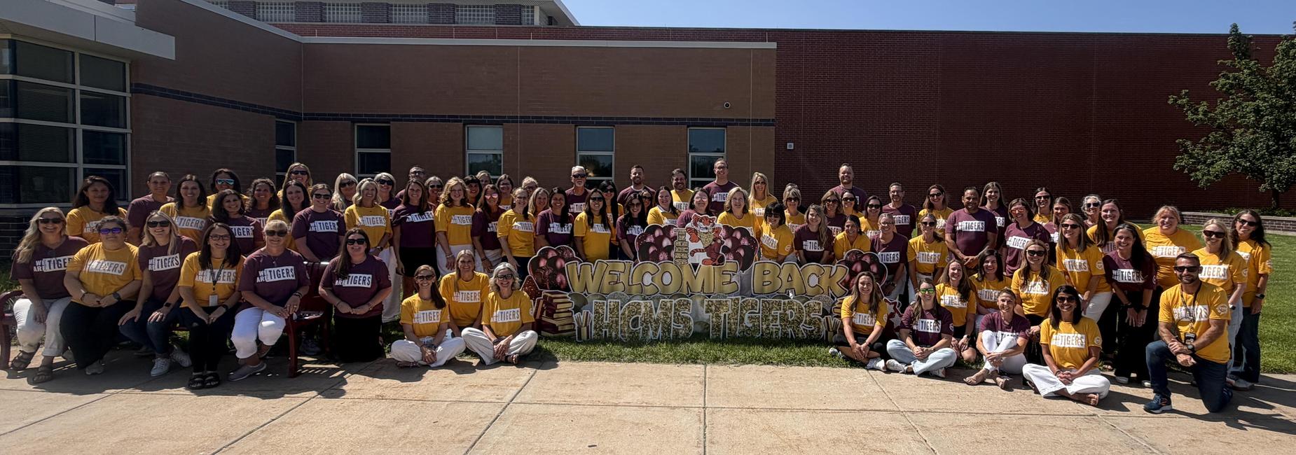 Group photo of teachers in matching shirts celebrating a welcome back event.
