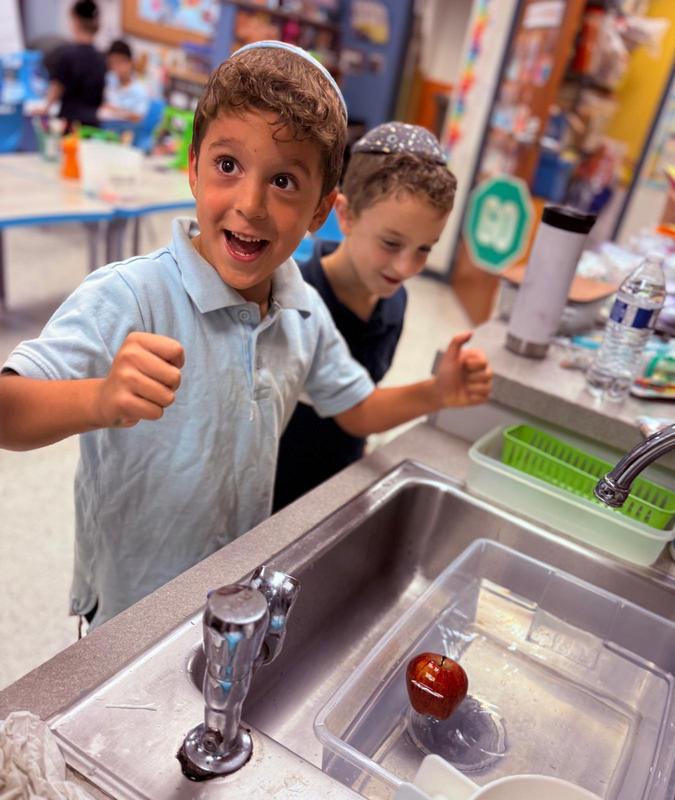 Boys test to see if an apple will float!