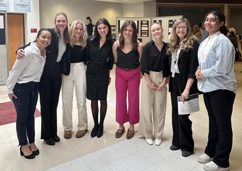 eight people lined up for photo