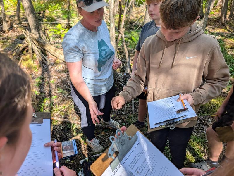 Group of people outdoors engaging in a hands-on learning activity.
