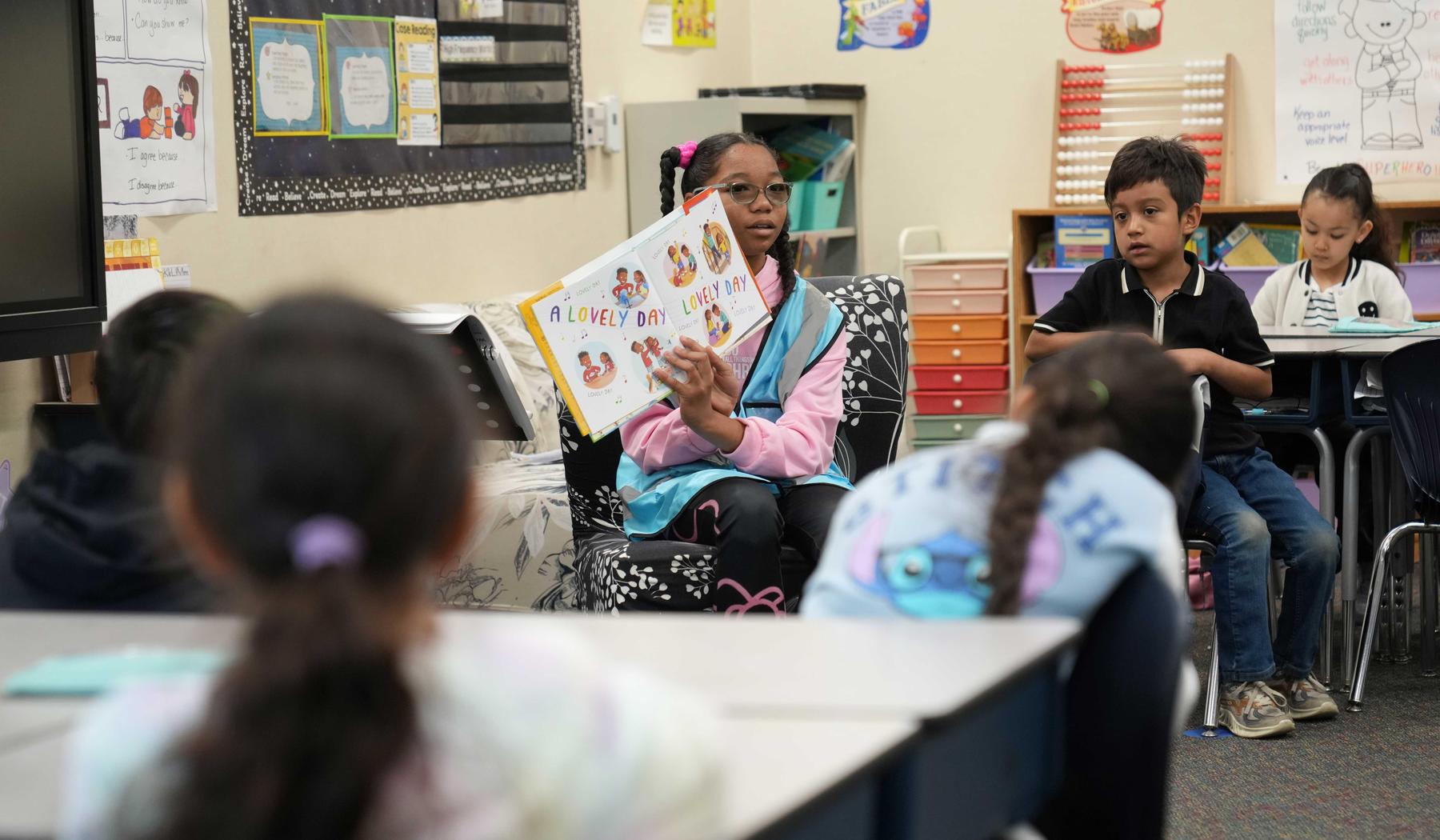 Girl reading to a class