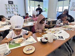 Trying food with chef hats on