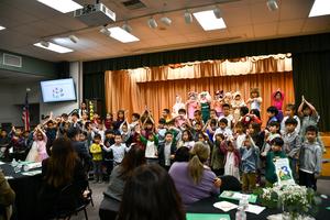 Kindergarten students perform the Habit Song on stage.