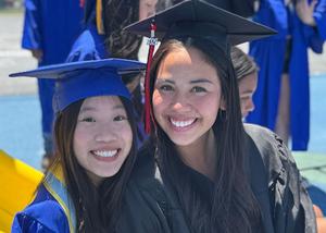 Two graduates wearing caps