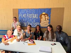 photo of flag football girls selling pancake tickets