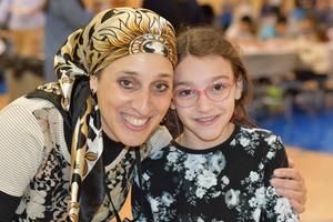 a mother and daughter posing at the fall festival