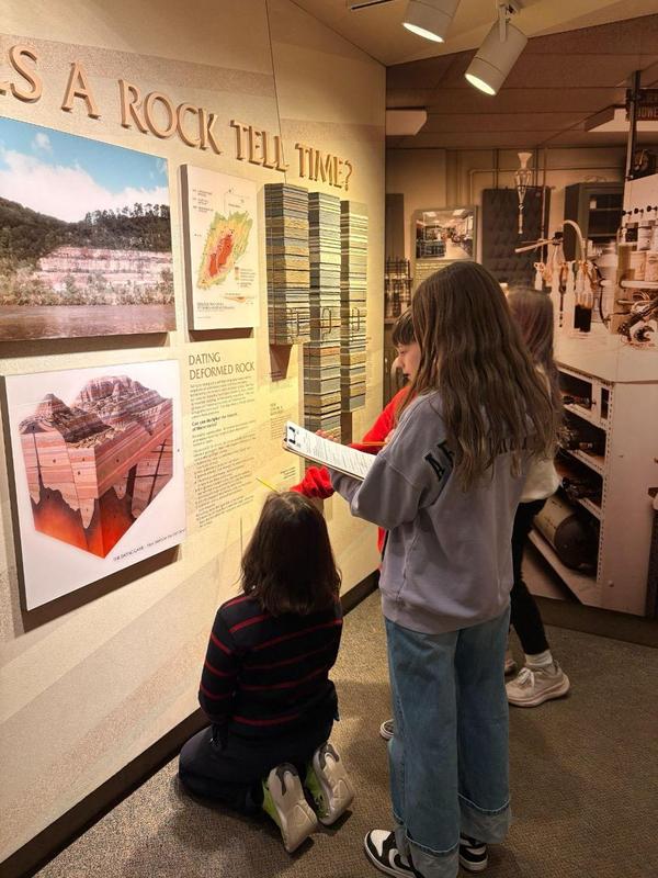 A team of four students examining an exhibit at the museum.