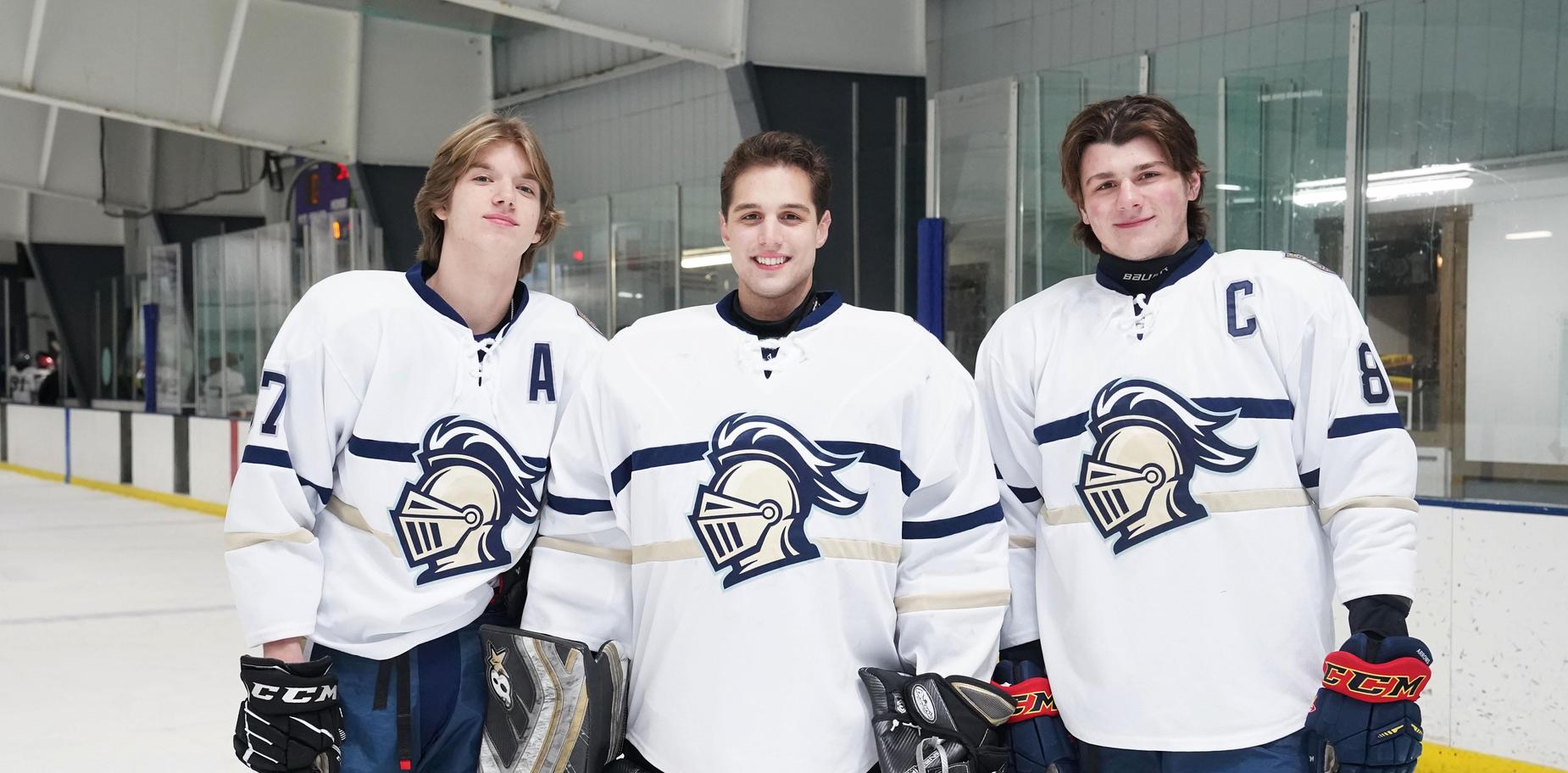 3 hockey players in uniform on ice