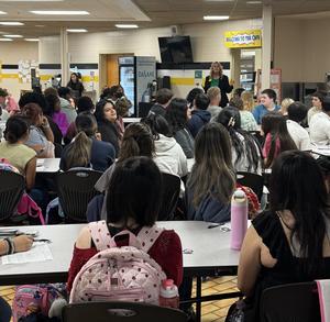 Mrs. Nowicki speaking to seniors in the commons.