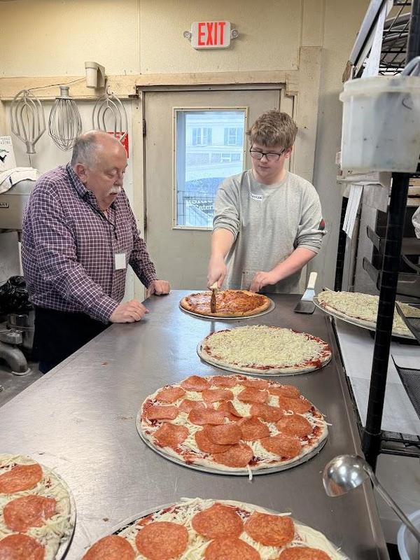 Hillside co-owner Craig White teaches pizza-making to PEP student