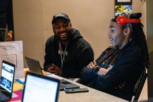 Leon Ford and a student chat