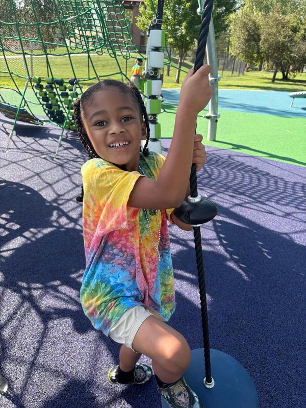 A scholar swings on the Miller Park playground
