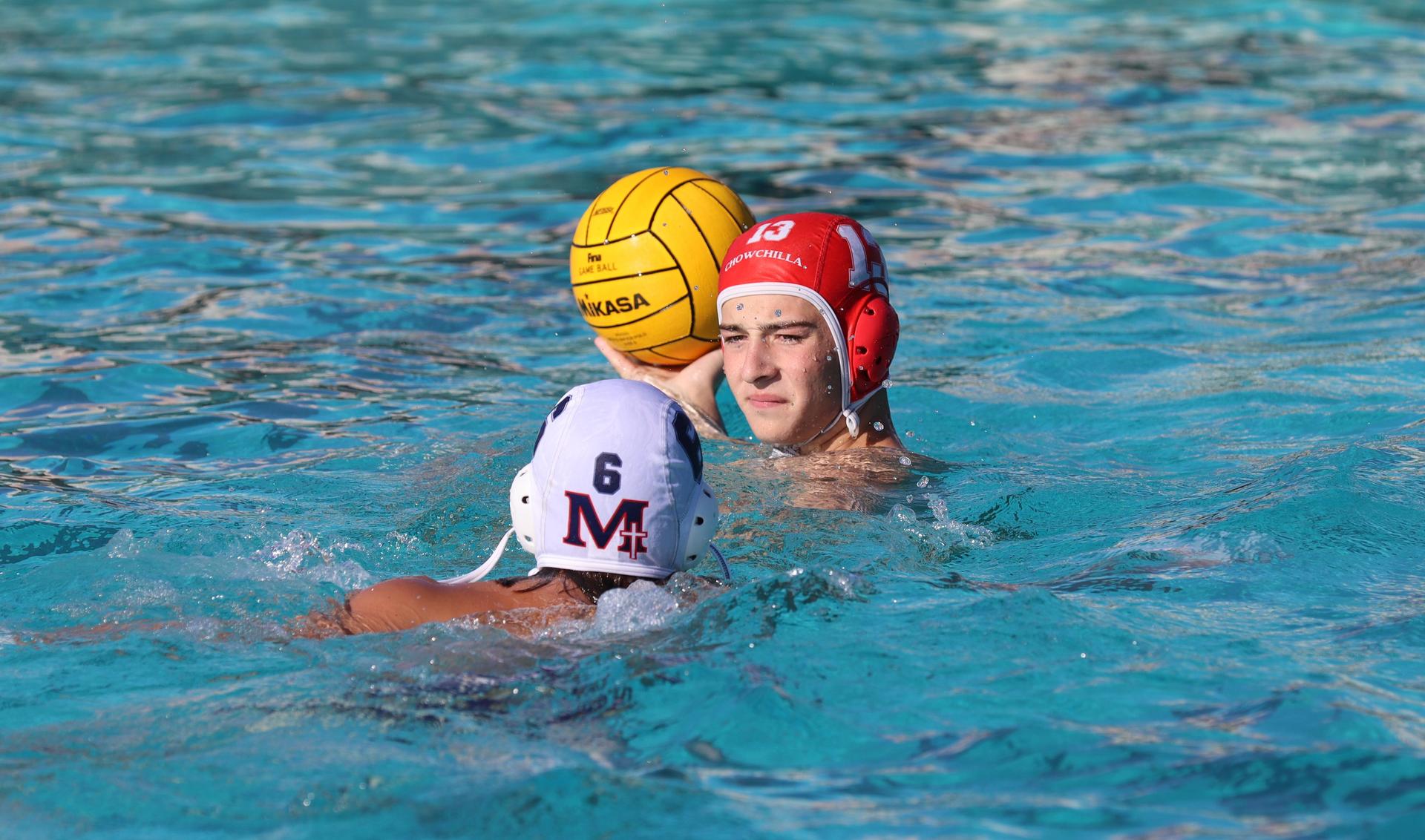 boys water polo players in action against san joaquin memorial