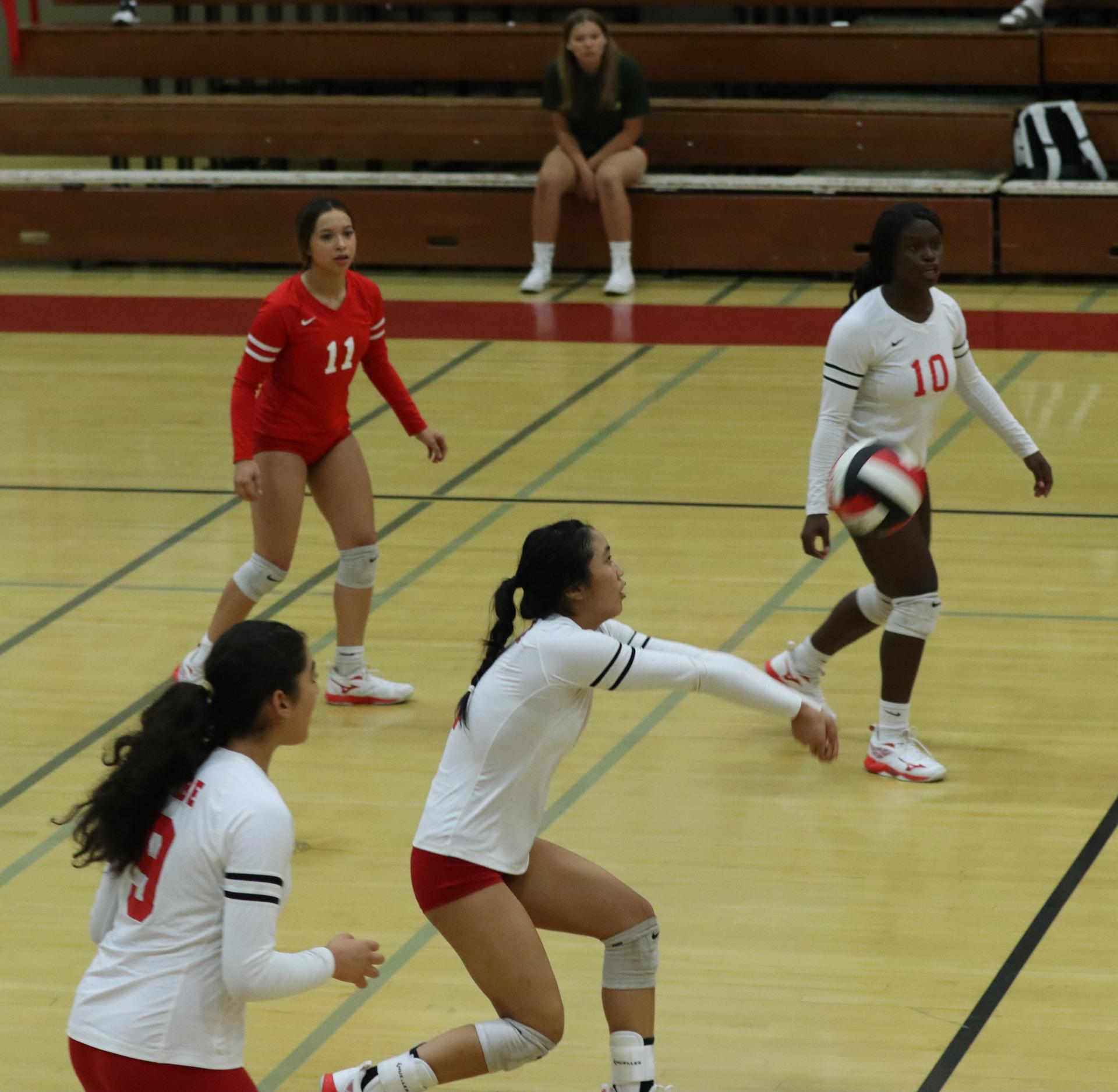 varsity volleyball players in action against golden valley