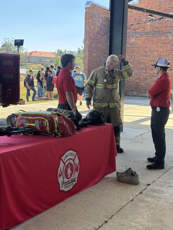 Student trying on fire gear