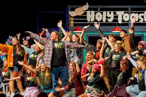 Whole cast of Godspell posting on stage after a big musical number.