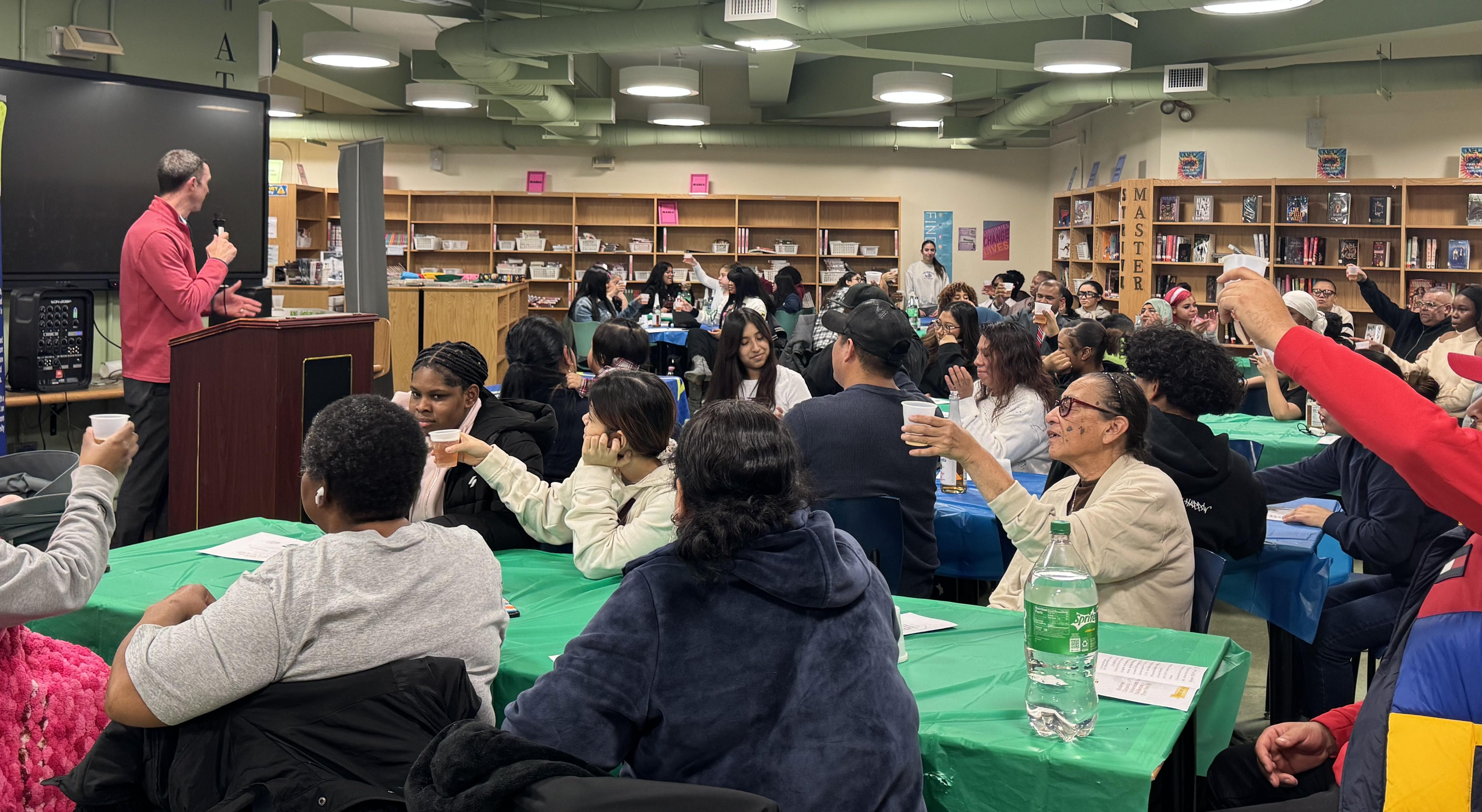 Parents and students together in the library.