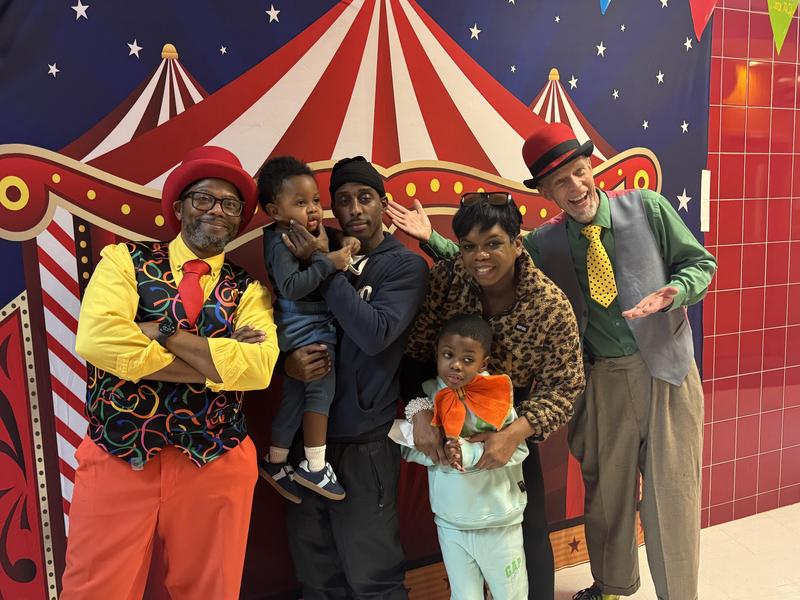Students and families in front of circus picture