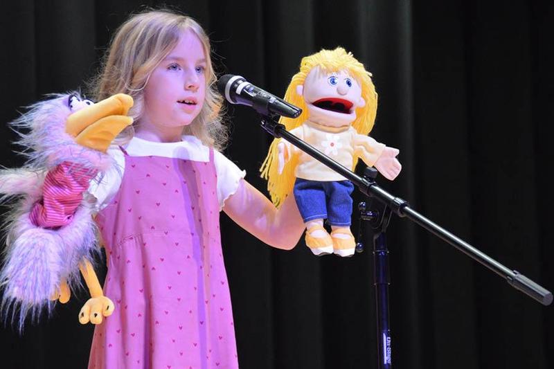 Second grader, Natalya Novickoff, displays her Ventriloquist skills at the talent show