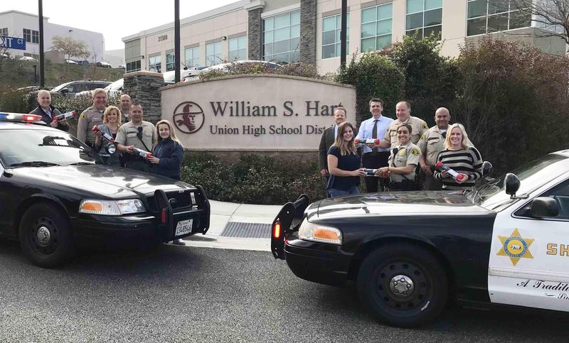 Hart District Administrators present School Resource Officers with Keep the Pressure Kits outside the District Office building.