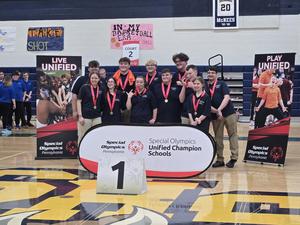 bocce team players with medals around neck and bocce signs around them