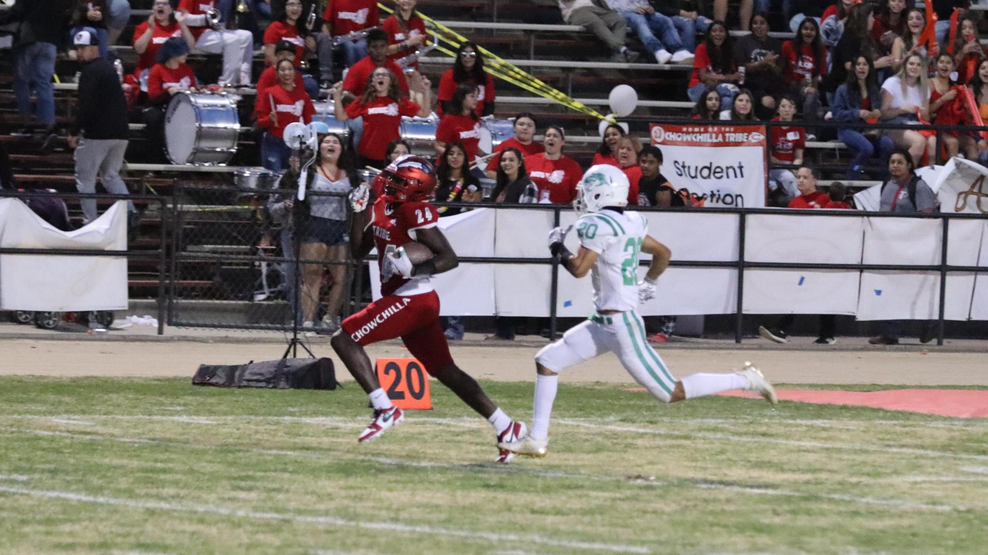 varsity football players in action against Riverdale